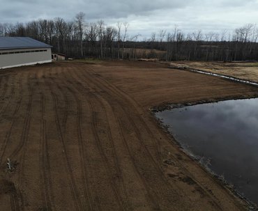 Harley Raking Topsoil To Prep Seed Bed